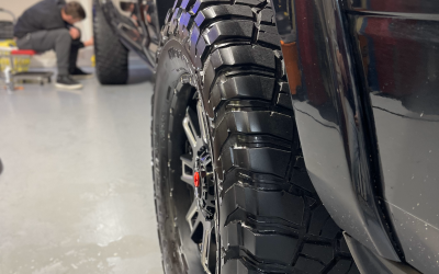 The truck tire that has been professionally detailed.